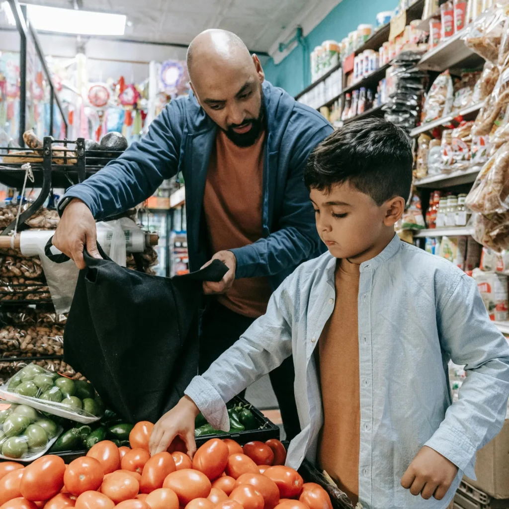 Boy grocery shopping with his father