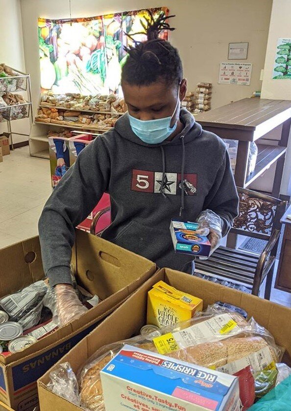  Calvin Brown prepares a food box at the Alamosa Food Bank 