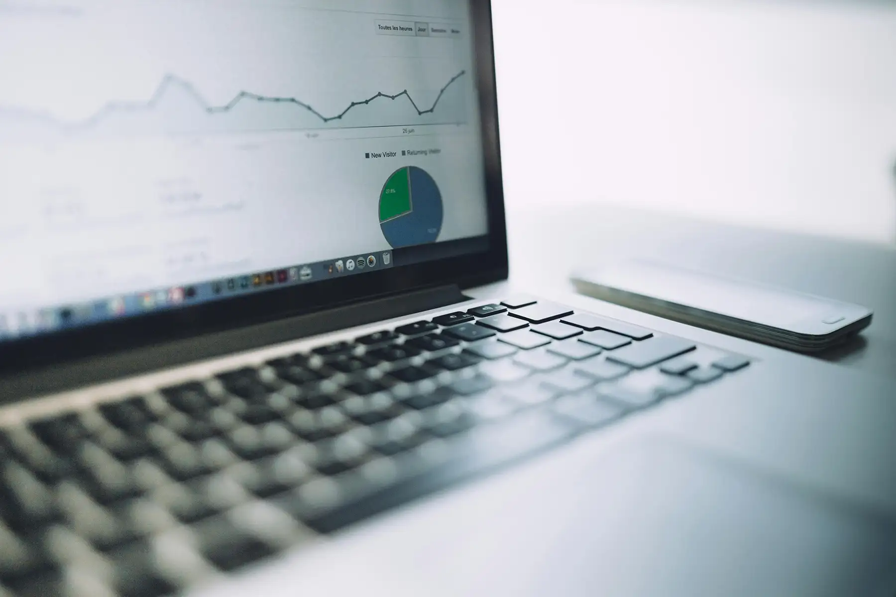 A laptop displaying a line graph of data