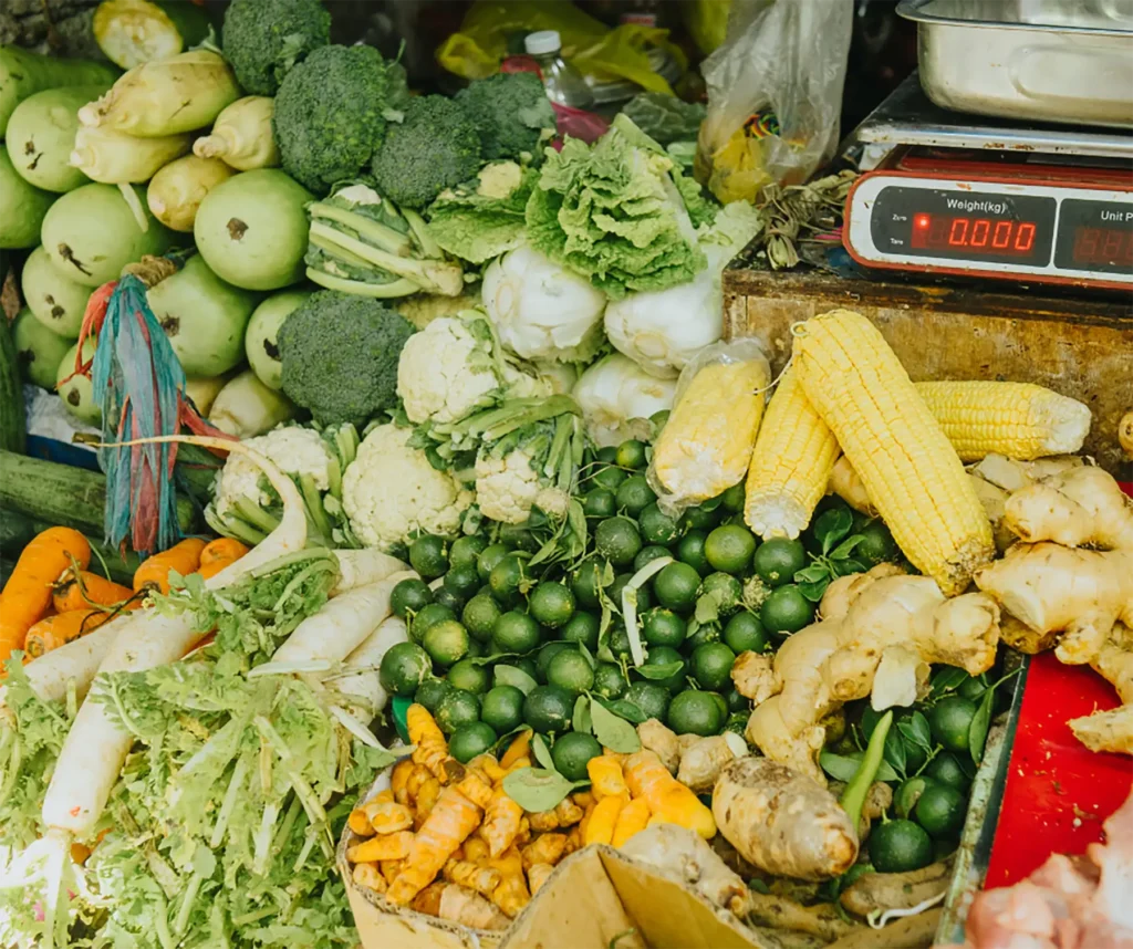 A bundle of produce ranging from carrots, corn, broccoli, lettuce and more