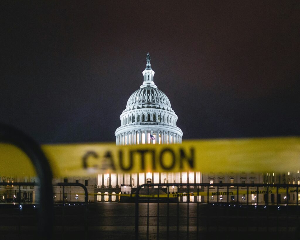 Slightly blurred caution tape in front of the U.S. Capitol Building in Washington, D.C.